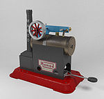 Een speelgoed stoommachine. Brandstof wordt verbrand in de bak onderin, stoom wordt gemaakt in de ketel die de zuiger (het blauwe deel) aandrijft, die het wiel laat draaien.  