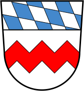 The zigzag bar is the allodic sign of the county of Scheyern, which can be traced in ducal seals from 1216 to around 1230, and which later appears in various colours in the coats of arms of sovereign monasteries. The Bavarian lozenge was not adopted by the Wittelsbach dynasty for their duchy of Bavaria until 1242 with the inheritance of the Counts of Bogen, a branch of the Babenberg dynasty. (The combination of both symbols is shown today in the coat of arms of the district of Dachau).
