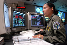 A U.S. Air Force soldier goes through a checklist for controlling GPS satellites in a satellite control room at Schriever Air Force Base in Colorado, U.S.