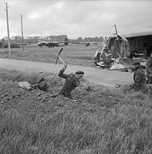 Soldiers of the 1st British Special Service Brigade digging defensive positions near the Orne River, June 7, 1944.