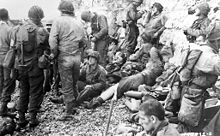 U.S. soldiers rest at Omaha Cliff, get resupplied, and prepare for the next attack.