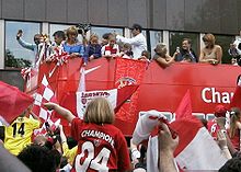 Arsenal FC players and supporters celebrate the 2004 championship win with a parade.