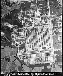 RAF aerial view of Birkenau, rising smoke from the incineration pits (August 1944)