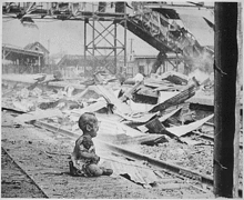 Crying infant after a bombing raid on Shanghai, August 28, 1937.