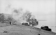 Burning British landing craft on the beach of Dieppe