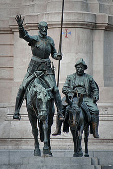 Don Quixote and Sancho Panza. Bronze figures at the monument to Cervantes (background) in Madrid.