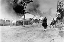 Two mounted German soldiers in a burning village near Mahiljou (Belarus), 16 July 1941