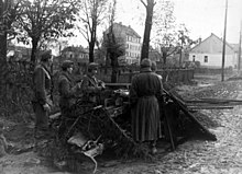 Hungarian soldiers with PAK fighting in a Budapest suburb. The war correspondent of the SS propaganda company commented in Nazi jargon: "November 1944, battle area Hungary. Only yesterday the enemy broke through here, but was immediately repulsed in the counterattack. [...] Hungarian Pak secures the sally-roads against renewed Bolshevik raids."