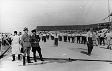 Propaganda photo: SS guards and prisoners, June 1938