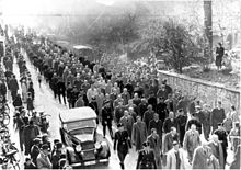 Propaganda photo: After the November pogrom, a column of Jews is taken to the concentration camp for so-called protective custody, Baden-Baden, November 1938.