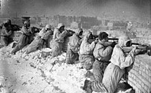 Soviet infantrymen in firing position on a roof during the fighting around Stalingrad, January 1943.