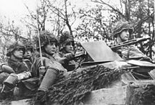 German soldiers in camouflaged infantry fighting vehicle at the front in the Belgian-Luxembourg area during the Battle of the Bulge, end of December 1944