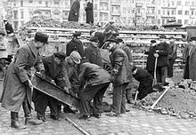 Volkssturm men dig steel girders to reinforce an anti-tank barrier at Hermannstrasse S-Bahn station in Neukölln on March 10, 1945