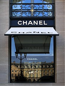 Chanel boutique at Place Vendôme in Paris with reflection of the Ritz Hotel in the shop window