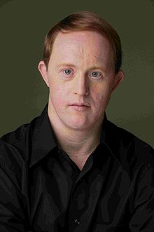 Portrait of Chris Burke, who has a mild form of trisomy 21, at age 42.