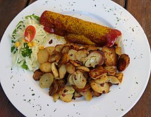 Currywurst with fried potatoes