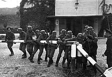 German soldiers and Danzig provincial police reenact the destruction of a Polish turnpike on the border to the Free City of Danzig, 1 September 1939.