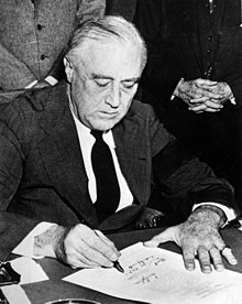 Franklin D. Roosevelt signs the declaration of war against Japan on December 8.