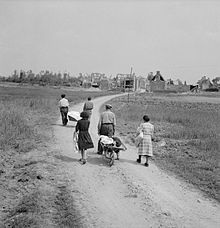 A French family returns on July 18 to their village of Buron, which was totally destroyed during the fighting.
