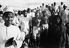 Gandhi (center of picture, with bowed head) during the Salt March.