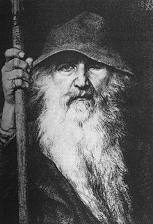 Een beeld van Odin de Zwerver, met grote hoed, vloeiende baard, mantel en staf.