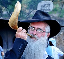 A man blows the shofar horn