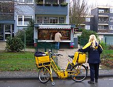 Delivery woman of the Deutsche Post AG with bicycle (2007)