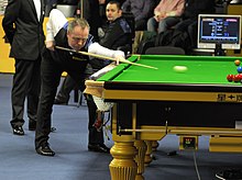 John Higgins in the bump stance: bump hand on the left, lead hand on the right (2013).