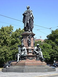 Maxmonument in Munich; the putti at the feet of King Maximilian II hold shields with the coats of arms of the provinces of Old Bavaria, Palatinate, Franconia and Swabia