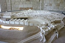 Model of Tell Megiddo showing settlement layers, in the foreground King Ahab's horse stables (left) and gate complex (right)