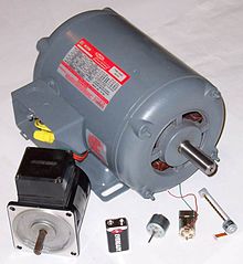 Various electric motors, with 9 V battery for size comparison
