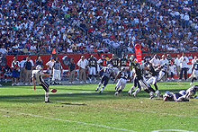 Josh Miller makes a punt for the New England Patriots.