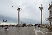 Monolithic columns (granite) with the lion as symbol of St. Mark (left) and the column with the marble statue of St. Theodore