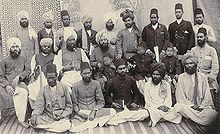 Mirza Ghulam Ahmad (center) and his early followers. To his right sits his later successor Nuur ud-Din