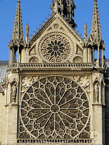 Large-scale rose window with filigree tracery in the Rayonnant style on the south transept of Notre-Dame Cathedral in Paris