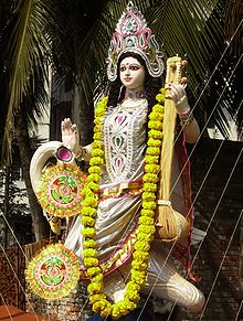 The goddess Sarasvati on a temporary altar on her feast day Vasant Panchami, in her left hand her instrument, the Vina