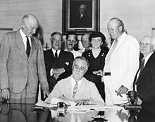 President Roosevelt signing the Social Security Act on August 15, 1935.