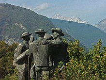 Monument in Ribčev Laz to the first climbers of Triglav. Triglav in the background