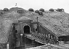 British troops passing a drawbridge on the Maginot Line at Fort de Sainghain, near the Belgian border.