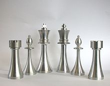 Chessmen turned with a CNC lathe. (The cross on the king and the battlements on the rooks cannot be made by turning, but require additional milling).
