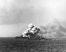The light carrier USS Princeton with the cruiser Reno providing assistance. The carrier's explosion also killed 85 of the crew of the cruiser Birmingham, which had come alongside to fight the fire.