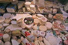 Different types of soft cheese on a market stall