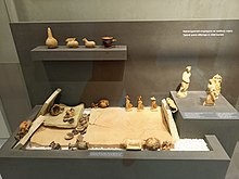 Finds in the Archaeological Museum of Corfu, 7th-3rd century BC, below the reconstruction of a child's grave from the 4th/3rd century BC.