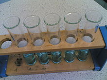 Test tubes in a wooden test tube stand.