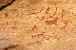 Hunters with bows and cattle as prey (rock paintings in the Sahara)