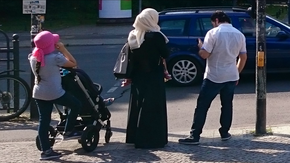 Woman with headscarf and ʿAbāya in Berlin.