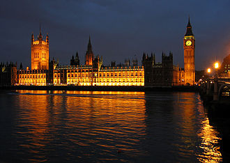 The House of Lords is located on the left underneath the Victoria Tower of the Palace of Westminster.