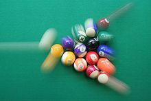Impulse in pool: The impulse of the white ball is distributed to all balls.
