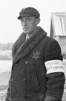 Um líder kapo no campo de concentração de Salaspils, Letônia, com uma braçadeira de Lagerpolizist (policial do campo).
