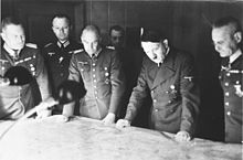 Adolf Hitler at the headquarters of the Commander-in-Chief of the Army, Field Marshal von Brauchitsch (1940). From left to right. at the map table: Wilhelm Keitel, Walther von Brauchitsch, Hitler, Franz Halder